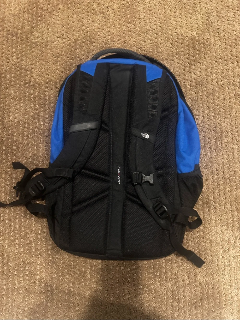 The North Face Blue and Black Backpack with Front Logo Connector